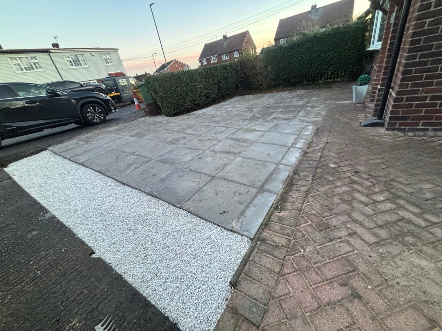 Paved driveway with gravel edging and a block-paved path leading to the front door